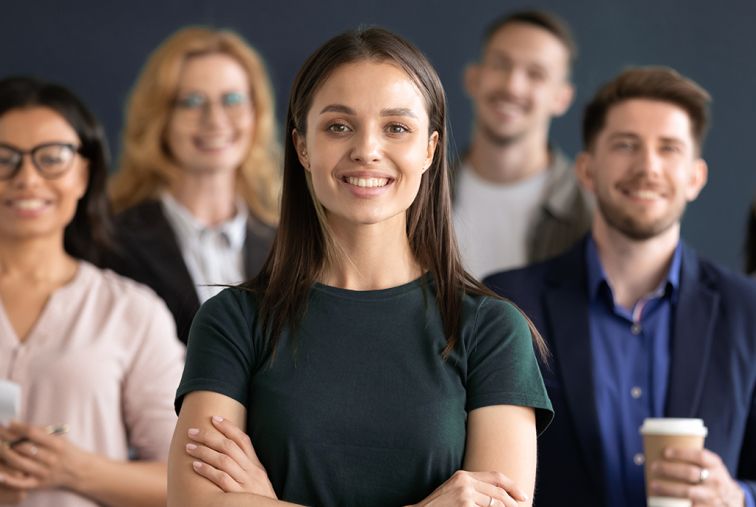 6 Co-workers standing, 4 women 2 men. Generic office coworkers.