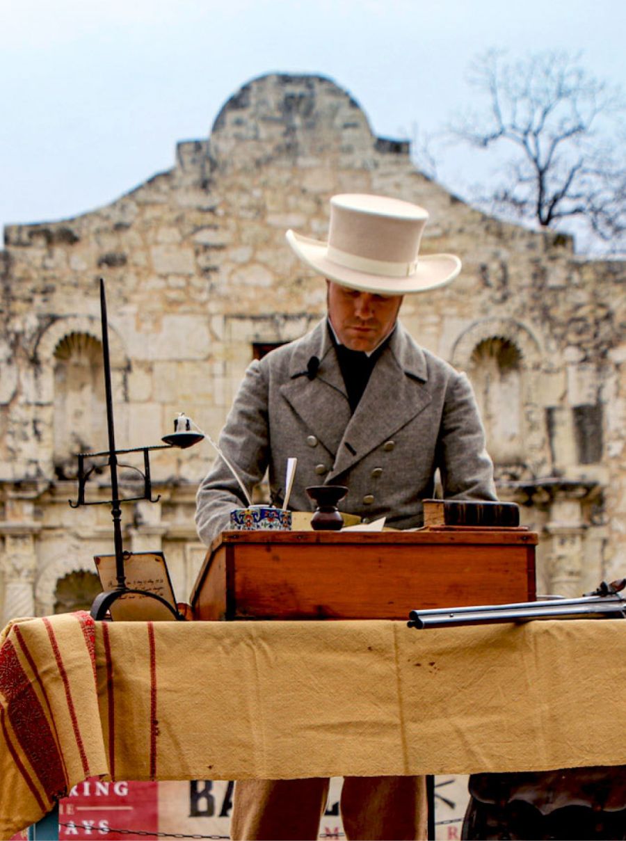 Man working in front of The Alamo